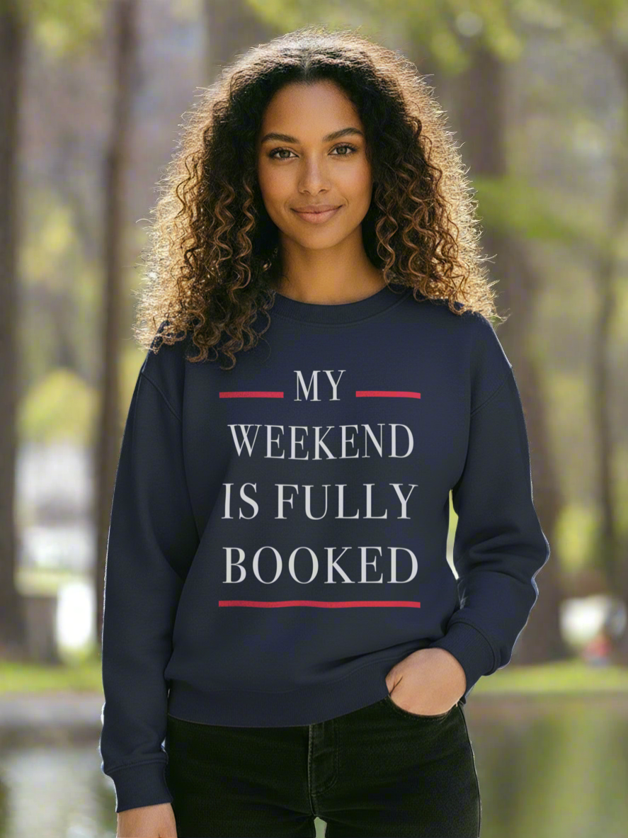 Model standing in the park with sweatshirt. Logo on sweatshirt “my weekend is fully booked”